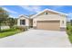 Attractive single-Gathering home featuring an attached 2-car garage and a manicured lawn at 306 Alexandrite St, Deland, FL 32720