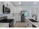 Stylish kitchen with white cabinets, quartz countertops, and stainless steel appliances at 306 Alexandrite St, Deland, FL 32720