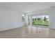 Bright living room with tile floors, large sliding glass doors, and a view of the backyard at 306 Alexandrite St, Deland, FL 32720