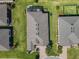 Aerial view of the home showcasing the roof, and well-maintained landscaping, nestled in a desirable neighborhood at 307 Bella Cortina Dr, Kissimmee, FL 34759