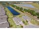 Beautiful house with lush landscaping, a brick driveway, and a water view at 307 Bella Cortina Dr, Kissimmee, FL 34759
