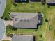 Aerial view of a well-maintained home with a screened-in lanai and lush green landscaping at 307 Bella Cortina Dr, Kissimmee, FL 34759
