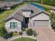 Desirable home with lush landscaping, a brick driveway, and a water view at 307 Bella Cortina Dr, Kissimmee, FL 34759