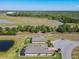 Scenic aerial view featuring a home with a screened lanai and a charming fenced yard by a pond at 307 Bella Cortina Dr, Kissimmee, FL 34759