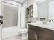 Neutral bathroom featuring a shower with tub, a vanity cabinet and medicine cabinet for storage at 307 Bella Cortina Dr, Kissimmee, FL 34759