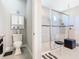 Bathroom featuring a glass-enclosed shower with tile accents and a vanity cabinet with decorative items at 307 Bella Cortina Dr, Kissimmee, FL 34759
