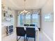 Bright dining area with lake views, modern chandelier, and stylish decor at 307 Bella Cortina Dr, Kissimmee, FL 34759