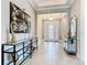 Grand entryway with high ceilings, tiled floors, stylish console table, and elegant decor at 307 Bella Cortina Dr, Kissimmee, FL 34759