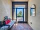 Inviting front entryway featuring brick floor, bench seating with accent pillows, and a charming mirror at 307 Bella Cortina Dr, Kissimmee, FL 34759