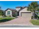 Beautiful home with a well manicured lawn, two-car garage, and lush landscaping at 307 Bella Cortina Dr, Kissimmee, FL 34759