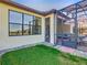 Exterior view of the home showcasing the screened lanai, well-manicured lawn, and seamless indoor-outdoor living at 307 Bella Cortina Dr, Kissimmee, FL 34759