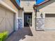 Stunning home with stone accents, a brick driveway, and a covered entryway at 307 Bella Cortina Dr, Kissimmee, FL 34759