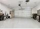 Spacious garage with ample storage space, overhead door, and clean flooring at 307 Bella Cortina Dr, Kissimmee, FL 34759