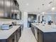 Contemporary kitchen featuring stainless steel appliances, white countertops, and dark cabinetry at 307 Bella Cortina Dr, Kissimmee, FL 34759