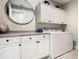 Functional laundry room with modern appliances, storage cabinets, and a clean design at 307 Bella Cortina Dr, Kissimmee, FL 34759