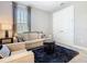 Relaxing living area with a plush sofa, and bright natural light at 307 Bella Cortina Dr, Kissimmee, FL 34759