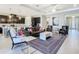 Open concept living room with modern furniture, dark cabinetry, and seamless connection to the kitchen at 307 Bella Cortina Dr, Kissimmee, FL 34759