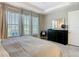 The main bedroom features an accent mirror, dresser, and large windows for natural light at 307 Bella Cortina Dr, Kissimmee, FL 34759