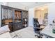The office features a stylish built-in bookcase and work desk in this naturally lit interior at 307 Bella Cortina Dr, Kissimmee, FL 34759