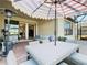 Relaxing outdoor patio with dining set, grill, and comfortable seating, perfect for entertaining and enjoying the outdoors at 307 Bella Cortina Dr, Kissimmee, FL 34759