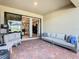 Inviting covered patio with brick pavers, comfortable seating, and access to the home's interior through sliding glass doors at 307 Bella Cortina Dr, Kissimmee, FL 34759
