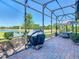 Spacious screened patio with view of lake, offering a serene outdoor living space with a view at 307 Bella Cortina Dr, Kissimmee, FL 34759