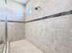 Shower features neutral tile with an accent band of black mosaic tile at 307 Bella Cortina Dr, Kissimmee, FL 34759