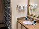 Well-lit bathroom featuring granite countertop, fresh towels, and a decorative shower curtain at 3100 Parkway Blvd # 113, Kissimmee, FL 34747