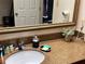 A well-lit bathroom features a clean design, granite vanity and decorative mirror at 3100 Parkway Blvd # 113, Kissimmee, FL 34747