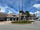 Welcoming clubhouse exterior with palm trees, inviting entrance, and ample parking at 3100 Parkway Blvd # 113, Kissimmee, FL 34747