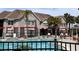 Community pool and hot tub surrounded by lounge chairs and well-maintained landscaping at 3100 Parkway Blvd # 113, Kissimmee, FL 34747