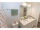Well-lit bathroom with double sinks, white cabinetry, and a large mirror at 3173 Armstrong Spring Dr, Kissimmee, FL 34744