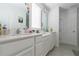 Bathroom with a double sink vanity with a large mirror, white cabinets, and tiled floor at 3173 Armstrong Spring Dr, Kissimmee, FL 34744
