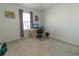 A simple bedroom featuring a built-in desk, a chair, and a bright window, providing a functional space at 3173 Armstrong Spring Dr, Kissimmee, FL 34744
