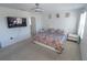 Cozy bedroom with ceiling fan, modern bed, two nightstands, and a wall-mounted television for entertainment at 3173 Armstrong Spring Dr, Kissimmee, FL 34744