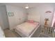 Bright bedroom with a ceiling fan, a crib, a bed, and cute decorations, creating a playful space at 3173 Armstrong Spring Dr, Kissimmee, FL 34744