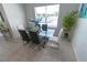 Bright dining area with a glass table, stylish chairs, and a large window at 3173 Armstrong Spring Dr, Kissimmee, FL 34744