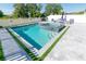 Stunning pool and spa with seating, framed by lush greenery and white picket fence at 3173 Armstrong Spring Dr, Kissimmee, FL 34744