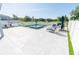 Spacious pool area with inviting seating, lush greenery and a white fence at 3173 Armstrong Spring Dr, Kissimmee, FL 34744