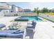 Backyard featuring a modern pool, spa, and patio furniture for relaxation at 3173 Armstrong Spring Dr, Kissimmee, FL 34744