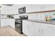 Modern kitchen with stainless steel appliances, white cabinets, and light countertops at 321 Alexandrite St, Deland, FL 32720