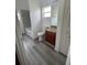 Bright bathroom featuring a toilet, vanity with sink, and a bathtub with gray wood look flooring at 322 Ashburton Way, Kissimmee, FL 34758