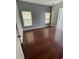 Bright bedroom features wood flooring and two windows with blinds for natural light, offering a cozy retreat at 322 Ashburton Way, Kissimmee, FL 34758