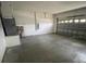 Spacious garage with concrete floors and a roll-up door, ready for parking and storage solutions at 322 Ashburton Way, Kissimmee, FL 34758