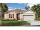 Charming single-Gathering home with a two-car garage, well-manicured lawn, and classic architectural details at 329 Alexandrite St, Deland, FL 32720