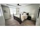 Bedroom with neutral walls, carpet and tray ceiling with ceiling fan above the dark wood four poster bed at 333 Almansa St, Davenport, FL 33837