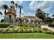Entrance to the Del Webb community with a beautiful water feature and landscaping at 333 Almansa St, Davenport, FL 33837