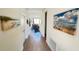 Bright hallway with tiled floors and beach-themed artwork leading to a comfortable living space at 333 Almansa St, Davenport, FL 33837