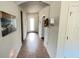 Inviting hallway with tile flooring, decorative artwork, and a view of the front door at 333 Almansa St, Davenport, FL 33837