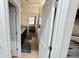 Hallway with doors leading to the bathroom and bedroom, ceramic tile floor and a beige accent wall at 333 Almansa St, Davenport, FL 33837